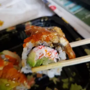 a close up of sushi with chopsticks