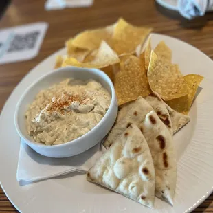 a bowl of dip and tortillas
