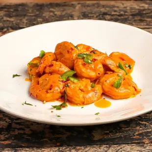 a plate of shrimp with sauce