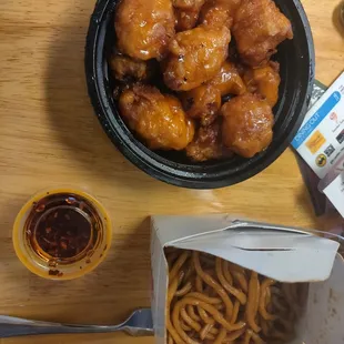 Medium orange chicken with udon noodles and optional chili oil.