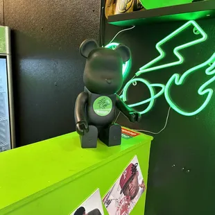 a neon green bear on top of a refrigerator