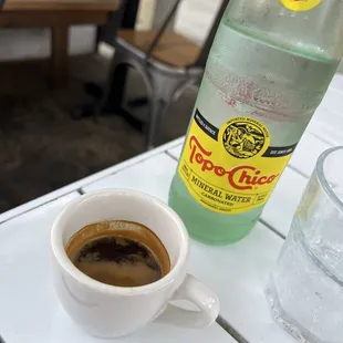 a cup of coffee and a bottle of water