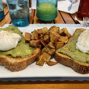 Avocado toast with poached eggs and home fries