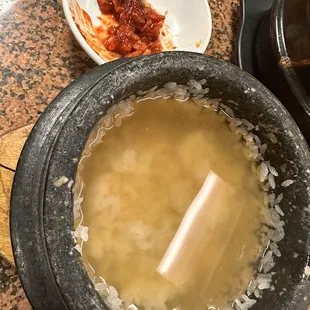 This is what it looks like after they add the barley tea. The crispy edges of rice will fall off the stone pot.