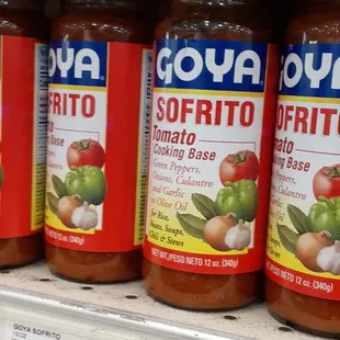 a shelf of goya sofrito sauces