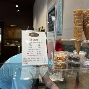 a man reaching for a scoop of ice cream