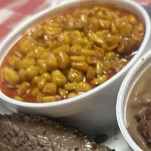 Delicious brisket, corn in cup, and beans with brisket.