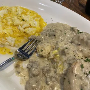 Biscuits and gravy with eggs, very large serving.