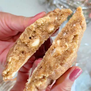 a hand holding a half eaten cookie