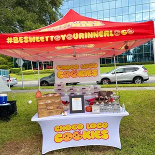 a booth with a red canopy