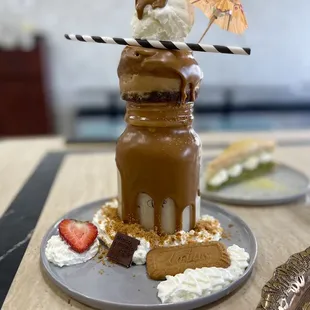 a chocolate milkshake with strawberries and whipped cream