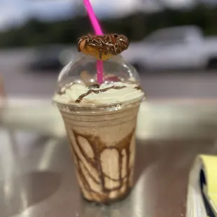 a chocolate drink with a pink straw