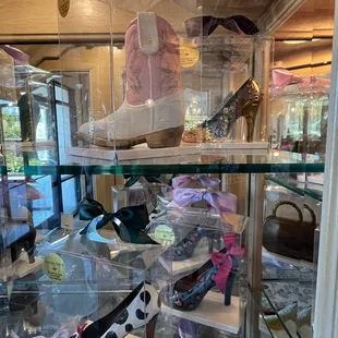 a variety of shoes in a display case