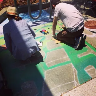 Midway through their chalk art masterpiece
