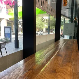 a wooden table in front of a store