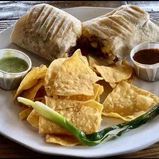 Famous B-Fast Burrito  Scrambled eggs, bacon, sausage, ham, house potatoes, onions, cheddar cheese, red and green salsa and pico de gallo.