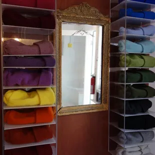 a closet with towels and a mirror