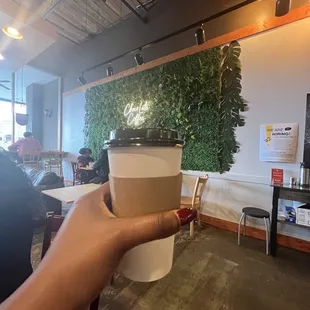 a person holding a cup of coffee