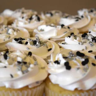 a plate of cupcakes with frosting and sprinkles