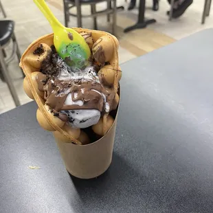 Create your own bubble waffles with vanilla gelato and chocolate syrup.