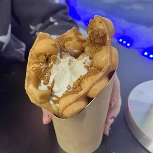 Create your own bubble waffles with vanilla gelato and biscotti cookies.