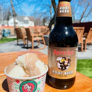 a bottle of root beer and a cup of ice cream