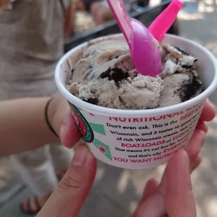 a person holding a cup of ice cream