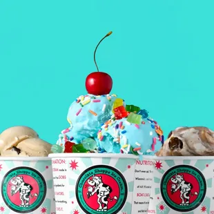 three scoops of ice cream with a cherry on top