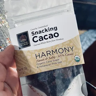 a hand holding a bag of chocolate