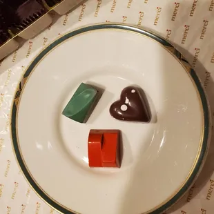 three pieces of chocolate on a plate