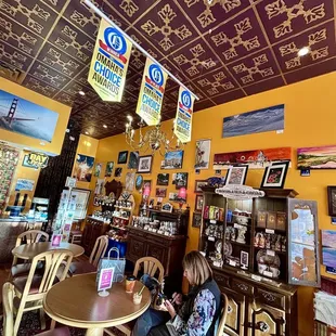 a kid sitting at a table in a cafe