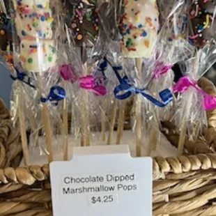 a basket of chocolate dipped marshmallows