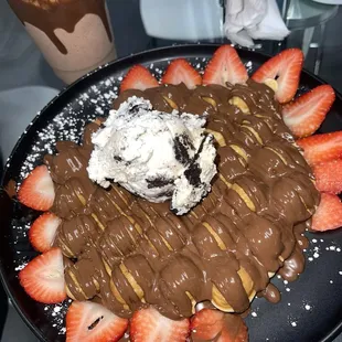 Bubble waffle, fresh strawberries, Nutella, Oreo ice cream scoop.