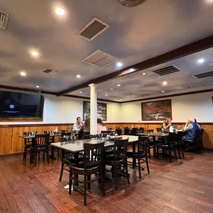 people sitting at tables in a restaurant