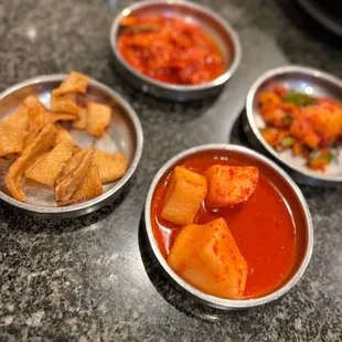 four bowls of different types of food