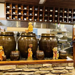 a kitchen with a stone countertop and a stone wall