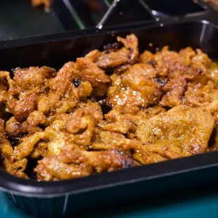 a close up of a dish of fried chicken