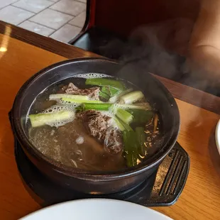 a bowl of soup with meat and vegetables