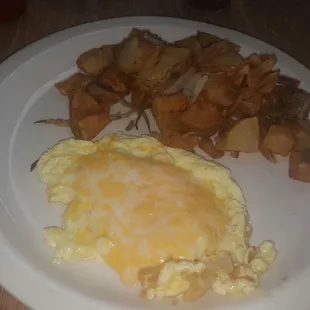 Scrambled eggs with cheese and crispy home fries.