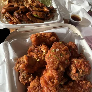 Korean fried chicken with spicy chicken teriyaki combo with gyoza in the back.