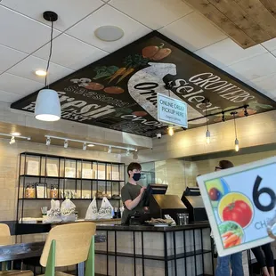 a woman holding a sign in a restaurant