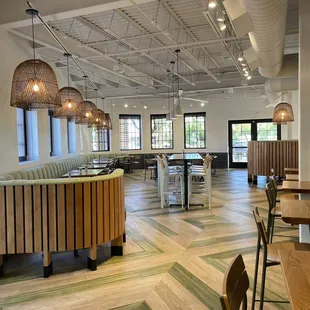 a restaurant with wood tables and chairs