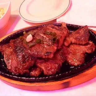 a platter of meat and vegetables