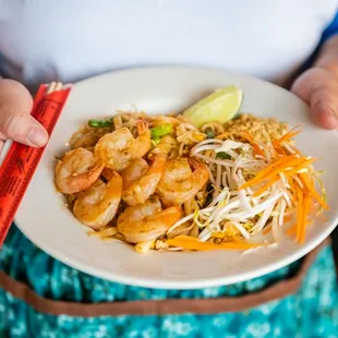 a woman holding a plate of food