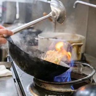a wok being cooked
