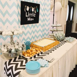 a table with a cake and cupcakes