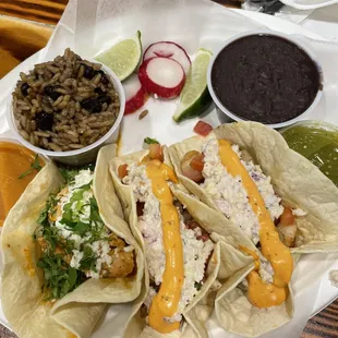 Taco platter - one shrimp, one chicken, and one fried rockfish. Refried beans and rice and beans on the side.
