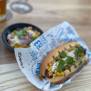 a hot dog in a bun with toppings