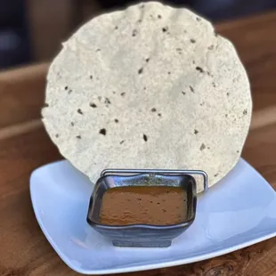 a tortilla and dipping sauce