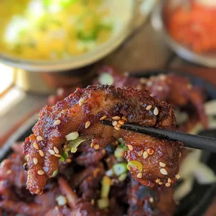 a closeup of a plate of food with chopsticks